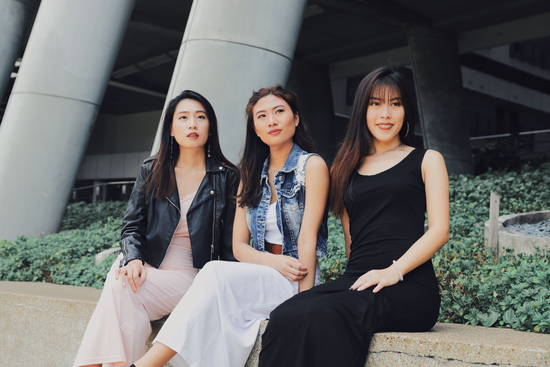 Friends Looking Away While Sitting In City