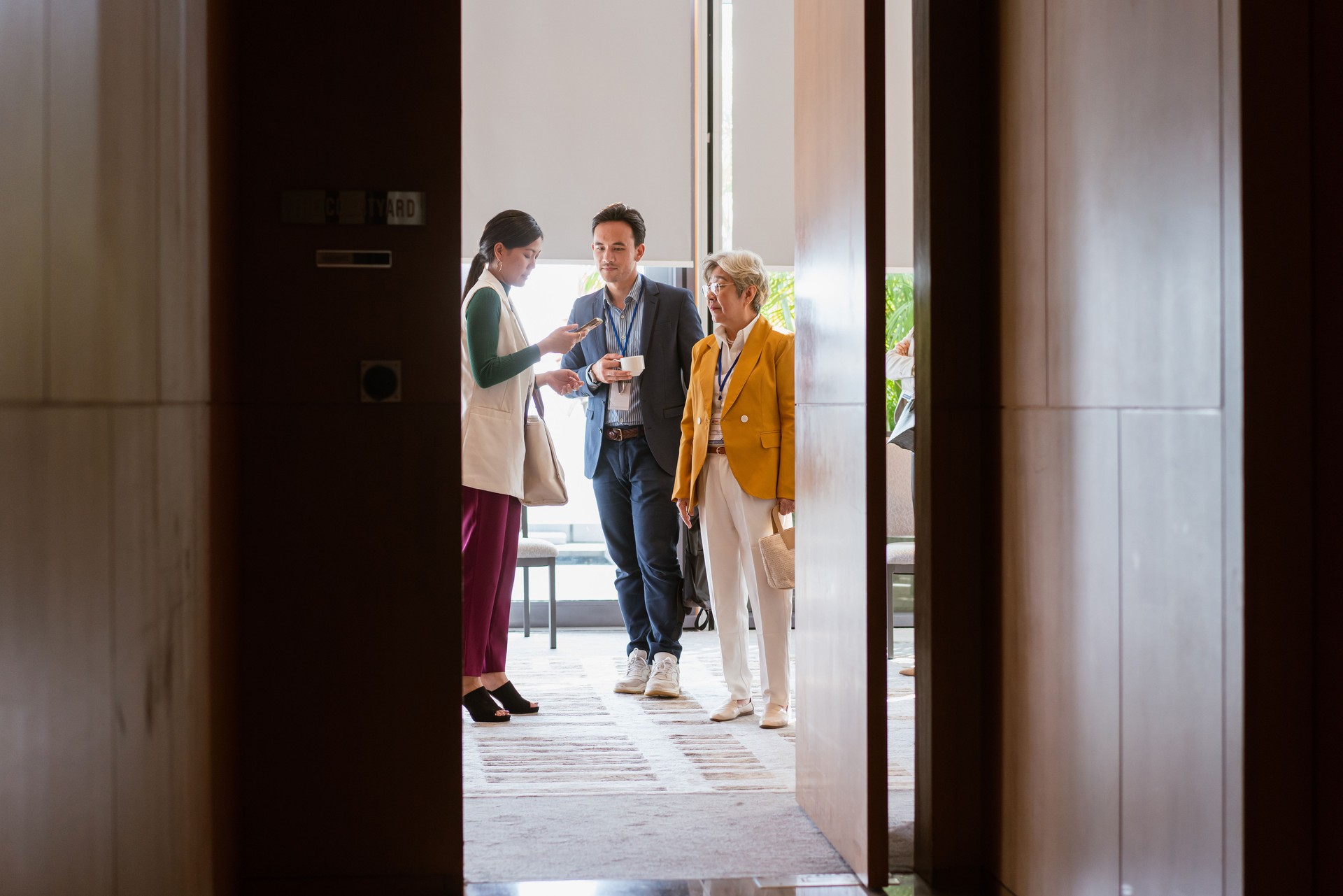 Group of business professionals congregate and network during a conference break